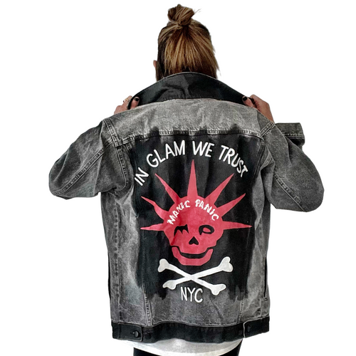 WOMAN WEARING A HAND PAINTED WREN AND GLORY DENIM JACKET WITH THE MANIC PANIC LOGO AND SKULLY LOGO