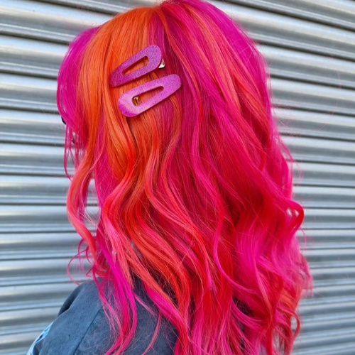 A woman with Manic Panic pink dyed hair with a pink hair clip 
