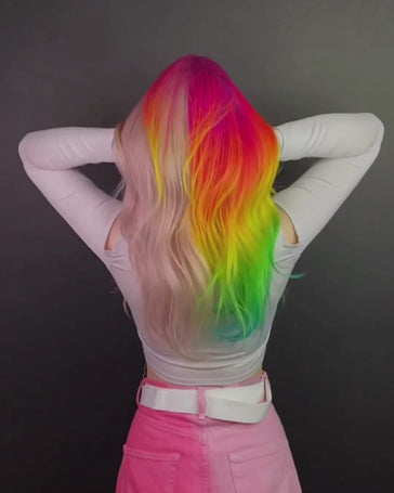 Woman with a Manic Panic pink and neon rainbow split dye showing of her hair.