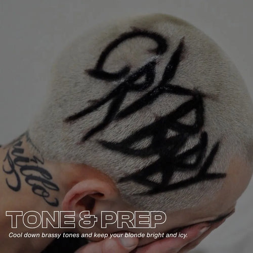 Male buzz cut in platinum blond, black letters on hair "cry baby"  text overlay tone & prep