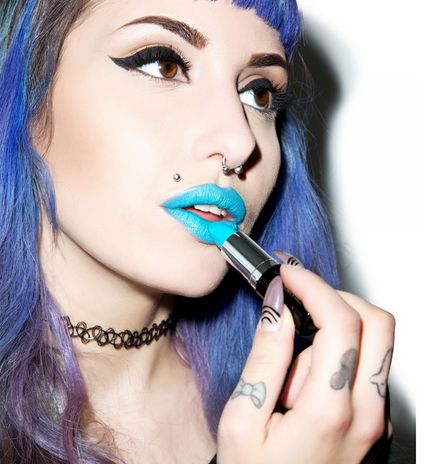 purple hair model applying blue lipstick with manic panic make-up
