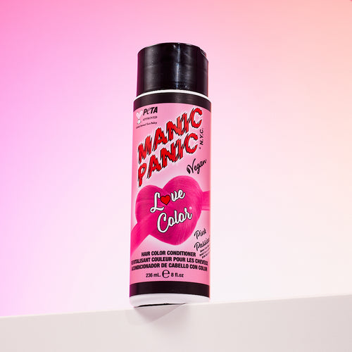 A bottle of Manic Panic® LOVE COLOR™ PINK PASSION® conditioner. The packaging features red and blue graphics with text emphasizing the vegan formulation.