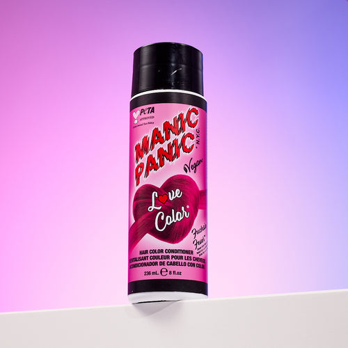 A bottle of Manic Panic® LOVE COLOR™ FUCHSIA FEVER® conditioner. The packaging features red and blue graphics with text emphasizing the vegan formulation.