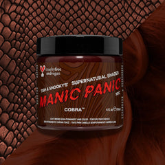 Manic Panic Cobra light brown hair color dye jar on top of a split diagnal background of brown cobra skin and a light brown wavy swatch  textured background