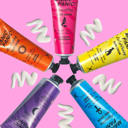Colorful hair care product tubes with white cream swashes on a pink background