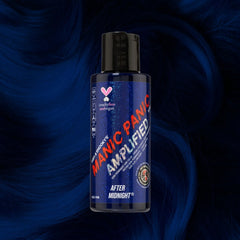 Manic Panic Amplified After Midnight navy blue hair dye bottle on deep blue wavy hair background