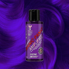 Manic Panic Amplified Electric Amethyst hair dye bottle on violet wavy hair background.