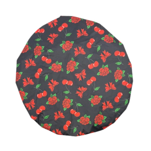 Top view of Manic Panic waterproof shower cap with red cherry and bow printed background