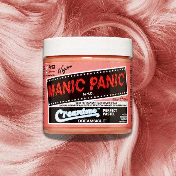 Manic Panic Classic High Voltage semi-permanent hair dye in shade Dreamsicle a vibrant, vegan hair color. Image shows a jar of Dreamsicle hair dye placed on top of a wavy orange pastel hair swatch.
