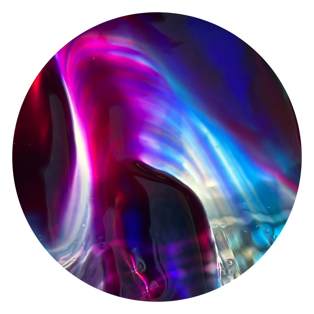 A circular glass art piece featuring an abstract, fluid design with vibrant swirls of magenta, purple, blue, and black, isolated on a white background.
