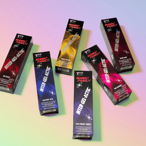 Six boxes of Manic Panicn Inter-Gel-Actic hair dye arranged on a pastel gradient background, showing different color variants including red, yellow, blue, purple, and pink.