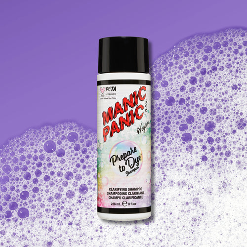 A bottle of PETA Certified Vegan Manic Panic Prepare to Dye Shampoo centered against a purple background with purple and white foam bubbles.
