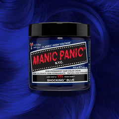 Manic Panic Classic High Voltage semi-permanent hair dye in shade Shocking Blue a vibrant, vegan hair color. Image shows a jar of Shocking Blue hair dye placed on top of a wavy shocking blue hair swatch.
