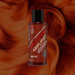 Manic Panic SuperNaturals Tiger’s Eye hair dye bottle on copper-brown wavy hair background