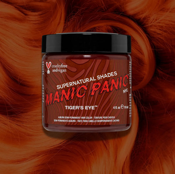 Manic Panic Classic High Voltage semi-permanent hair dye in shade Tiger's Eye a vibrant, vegan hair color. Image shows a jar of Tiger's Eye hair dye placed on top of a wavy copper  hair swatch.
