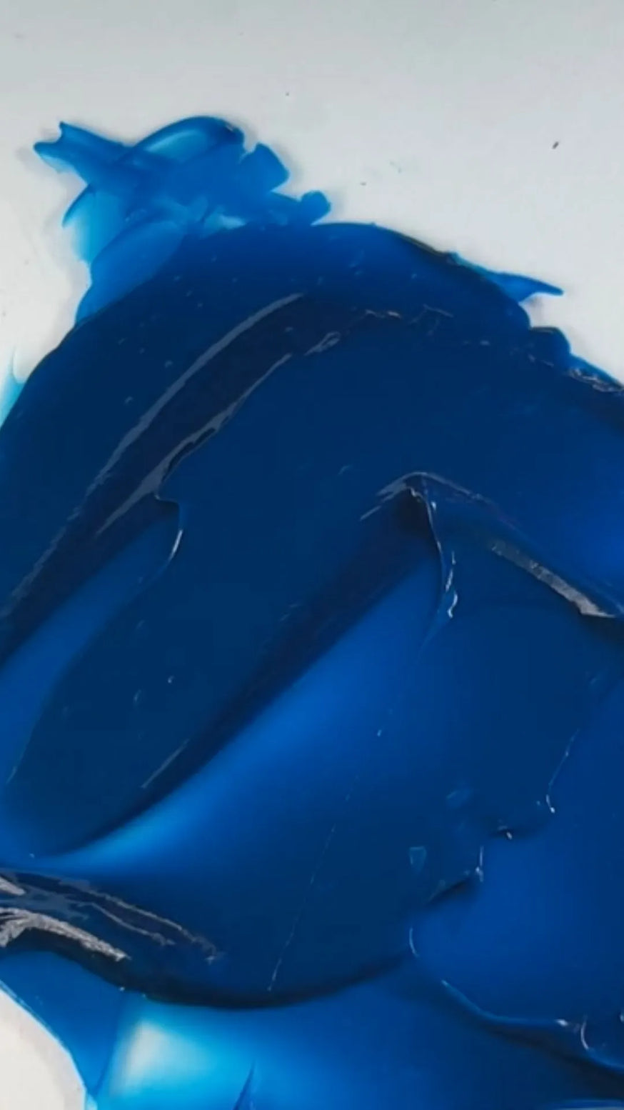 static Close-up of blue semi-permanent hair dye being mixed with a spatula, showing rich, vibrant gel texture for bold DIY blue hair color results